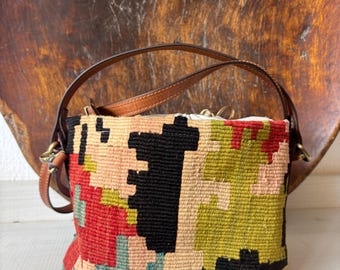 Vintage kilim bag, leather bucket bag with shoulder straps. Tobacco pouch closure with decorative beads. Measures 20x17 cm