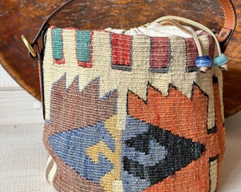 Vintage kilim bag, leather bucket bag with shoulder straps. Tobacco pouch closure with decorative beads. Measures 20x21 cm