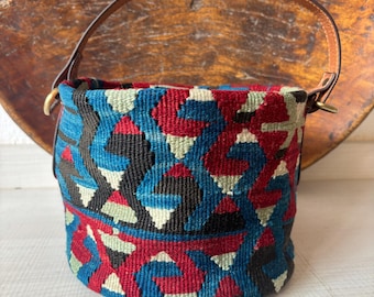 Vintage kilim bag, leather bucket bag with shoulder straps. Tobacco pouch closure with decorative beads. Measures 20x17 cm