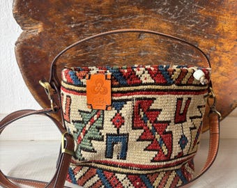 Vintage kilim bag, leather bucket bag with shoulder straps. Tobacco pouch closure with decorative beads. Measures 20x17 cm