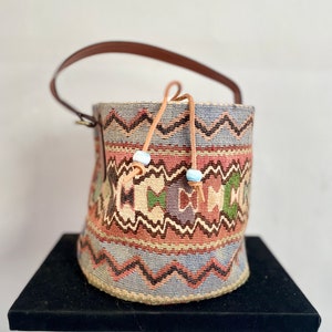 Vintage kilim bag, leather bucket bag with shoulder strap handles. Tobacco bag closure with decorative beads measures 20x21 cm