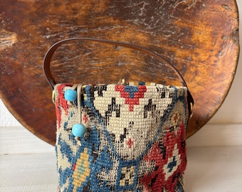 Vintage kilim bag, leather bucket bag with shoulder straps. Tobacco pouch closure with decorative beads. Measures 20x17 cm