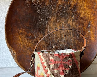 Vintage kilim bag, leather bucket bag with shoulder straps. Tobacco pouch closure with decorative beads. Measures 20x17 cm