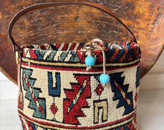 Vintage kilim bag, leather bucket bag with shoulder straps. Tobacco pouch closure with decorative beads. Measures 20x17 cm