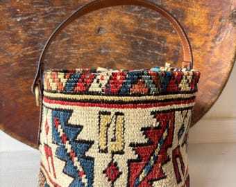 Vintage kilim bag, leather bucket bag with shoulder straps. Tobacco pouch closure with decorative beads. Measures 20x17 cm