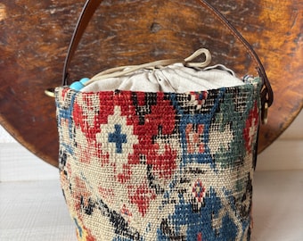 Vintage kilim bag, leather bucket bag with shoulder straps. Tobacco pouch closure with decorative beads. Measures 20x17 cm
