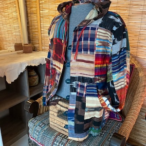 May include: A multi-colored patchwork hooded jacket with a variety of patterns, including plaid, stripes, and ikat. The jacket is made of a soft, comfortable fabric and has a relaxed fit.