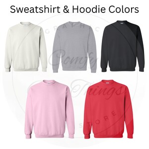May include: Five different color sweatshirts. The colors are white, grey, black, pink, and red.