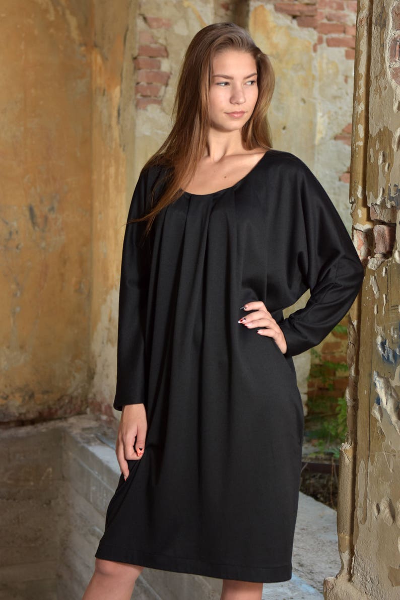 black dress with sweater over it