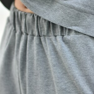 May include: Gray sweatpants with an elastic waistband.
