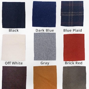 May include: Catalog of nine wool fabric swatches in various colors, including black, dark blue, blue plaid, off white, gray, brick red, dark brown, pumpkin, and khaki.