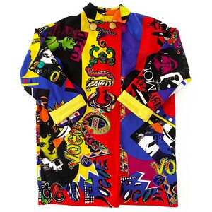 May include: A long-sleeved shirt with a colorful patchwork design featuring various patterns and the word "Vogue" repeated throughout. The shirt is made of a silky fabric and has a button-up front.