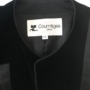 May include: Black velvet vest with a black satin trim and a white label that reads "Courr&egrave;ges Paris 9AR".