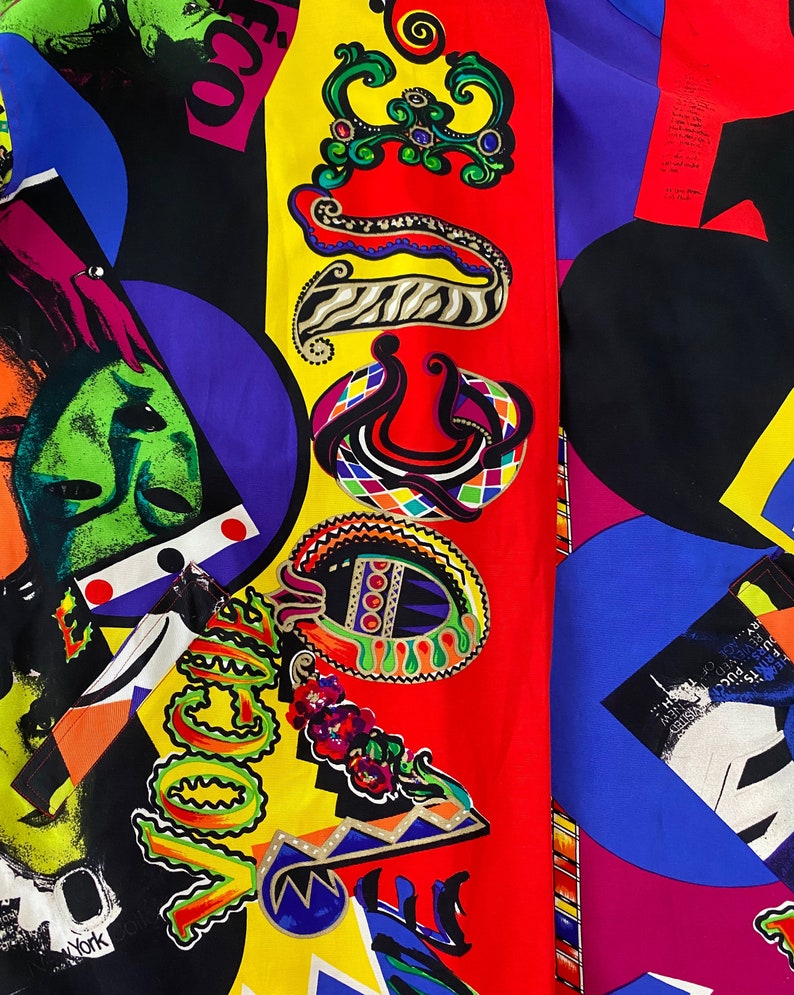 May include: A colorful fabric with a geometric pattern featuring a red, yellow, and blue color scheme. The fabric has a variety of shapes and designs, including circles, squares, and swirls. The fabric also features the word "Vogue" in a stylized font.