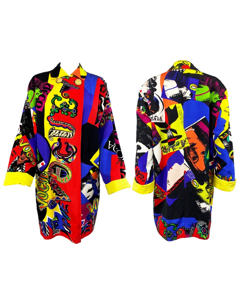 May include: A long-sleeved jacket with a colorful, abstract print featuring geometric shapes, faces, and text. The jacket is made of a black fabric with yellow, red, blue, and green accents.
