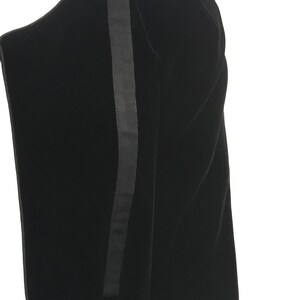 May include: Black velvet dress with a black satin stripe down the side.