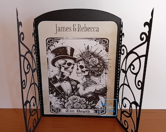 May include: A black and white illustration of a skeleton couple in wedding attire. The image is framed with a black ornate border and the text "James & Rebecca" and "Till Death" are visible.