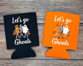 May include: Two Halloween-themed can coolers, one black and one orange. Each cooler features the text "Let's go Ghouls" in white, along with a graphic of a pumpkin, skeleton, and ghost. The coolers are designed to hold beverage cans.