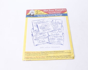 May include: A pack of iron-on transfers featuring seven designs of blue and white chinaware with the days of the week written on each piece. The pack is yellow and white with the text "Aunt Martha's Hot Iron Transfers" and "3764 - Fine Chinaware".
