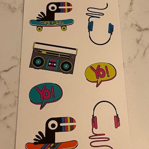 May include: A set of nine stickers featuring a cartoon bird on a skateboard, a boombox, headphones, and speech bubbles that say "Yo!" The stickers are on a white background.