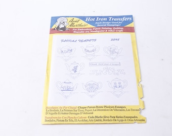 May include: A sheet of Aunt Martha's Hot Iron Transfers with floral teapot designs. The sheet shows multiple blue teapot illustrations, with the text "FLORAL TEAPOTS" and "8898". It is for embroidery, fabric painting, and other crafts.