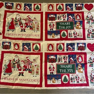 May include: A cream-coloured fabric panel with a red border features a Christmas-themed design. The panel includes illustrations of Santa Claus, snowmen, and Christmas trees. The text "I believe in Santa Claus" and "Share the Joy" is printed on the panel.