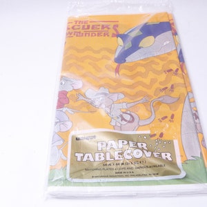 May include: A yellow and orange paper table cover featuring characters from The Rescuers Down Under. The cover has a snake, a mouse, and a kangaroo on it. The text "The Rescuers Down Under" and "Paper Tablecover" is printed on the cover.