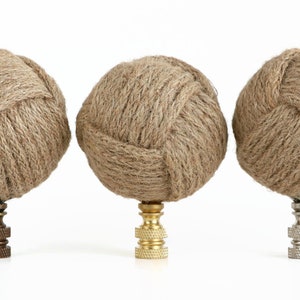 May include: Three decorative finials made of natural jute rope, each with a different finish: antique brass, polished brass, and nickel.