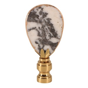 May include: A gold lamp finial with a white and gray marble-like top.