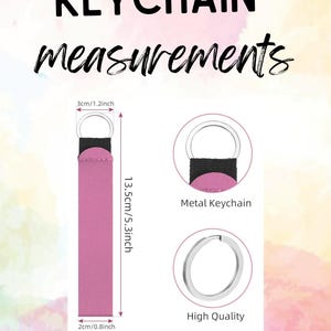 May include: A pink keychain with a black fabric loop and a silver metal ring. The text KEYCHAIN measurements is at the top. Dimensions are 1.2 inches wide by 5.3 inches long, with a 0.8 inch base width. Includes close-up views of the metal ring.