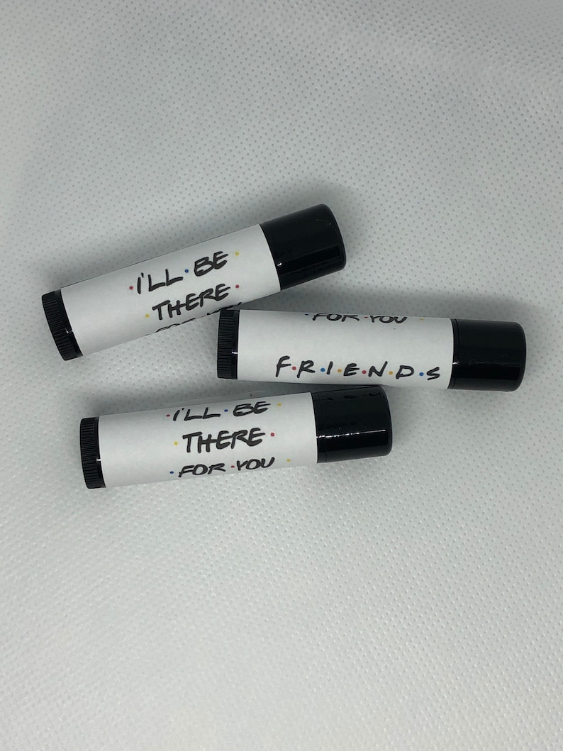 May include: Three black lip balm tubes with white labels. The labels have the text "I'll be there" and "For you" on two of the tubes. The third tube has the text "F.R.I.E.N.D.S" on the label.