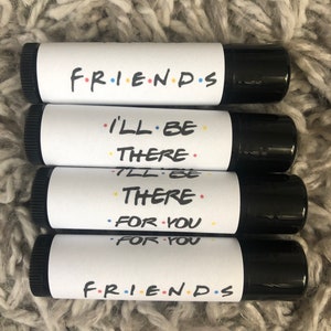 May include: Four black and white lip balm tubes with the words "FRIENDS" and "I'LL BE THERE FOR YOU" printed on them.