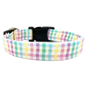 May include: A pastel pink, yellow, green, and blue gingham dog collar with a black plastic buckle.