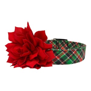 May include: A red fabric flower attached to a green, red, and black plaid dog collar.