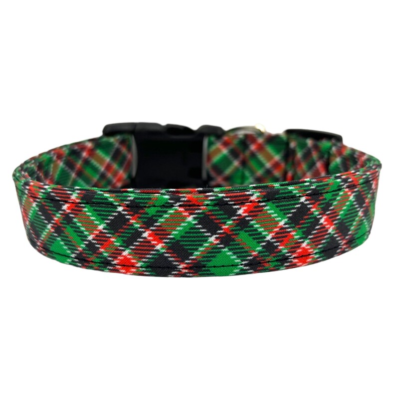 May include: A green, red, and black plaid dog collar with a black plastic buckle.