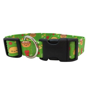 Green dog collar featuring a playful pattern of smiling tacos, chips and salsa, and saguaro cacti, designed with vibrant colors and a fun, food-themed vibe.