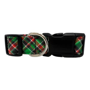 May include: A black and green plaid dog collar with a silver D-ring and a black plastic buckle.