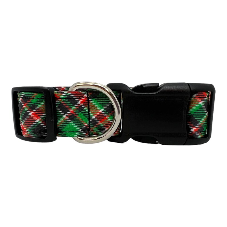 May include: A black and green plaid dog collar with a silver D-ring and a black plastic buckle.