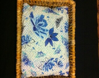 Butterflies and flowers print pillow in a wicker basket