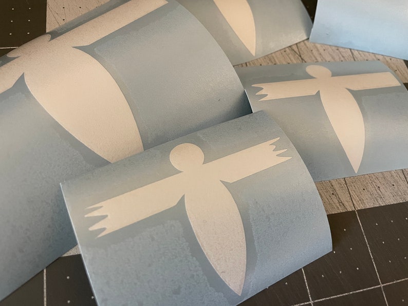 May include: Four sheets of blue vinyl with white stick-on decals of a stylized person with outstretched arms.