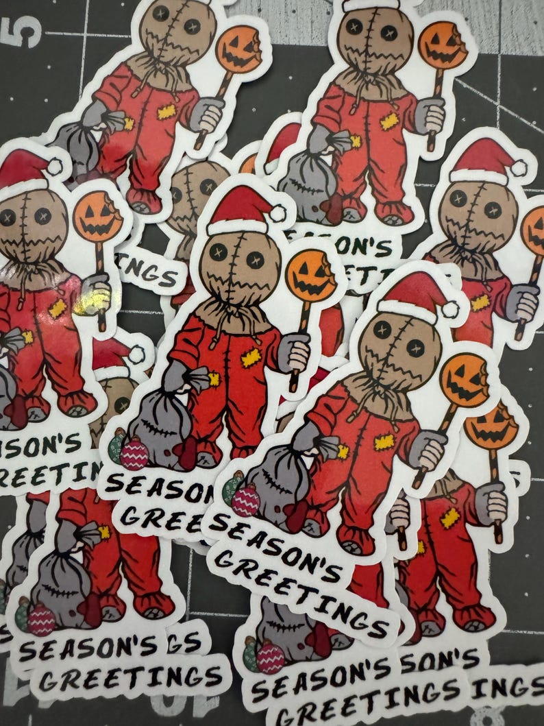 May include: A collection of stickers featuring a cartoon character dressed in a red jumpsuit and a Santa hat, holding a candy cane with a pumpkin on top. The stickers have different text, including "Season's Greetings" and "Season's Son's Greetings".