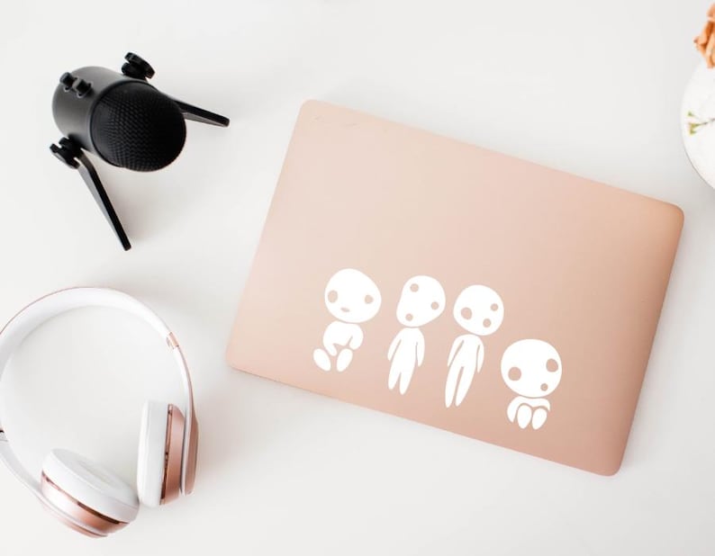 Kodama forest spirit vinyl decal applied to laptop for Studio Ghibli anime fan aesthetic.