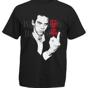 May include: Black t-shirt with a white image of Nick Cave and the Bad Seeds. The image shows Nick Cave giving the middle finger.