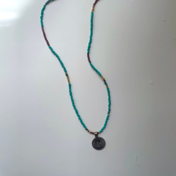 Turquoise beaded necklace with silver coin pendant