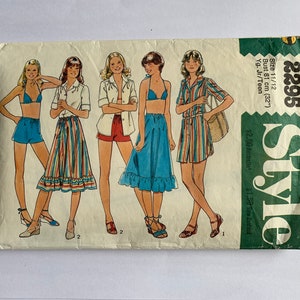 May include: A vintage sewing pattern envelope labelled Style 2295, size 11/12, bust 81 cm. The front features illustrations of five outfits including a bikini with shorts, a button-down shirt with a striped skirt, and a striped shirt dress.