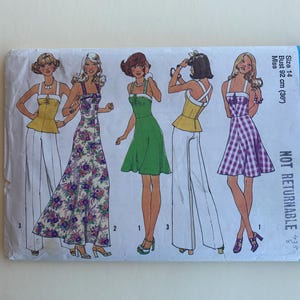 May include: A sewing pattern for four different styles of dresses. The pattern is for size 14, bust 36 inches. The pattern is from Simplicity and the pattern number is 6979.
