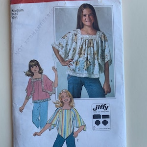 May include: Vintage Simplicity sewing pattern number 7831 for a girl's blouse. The pattern includes three different styles, all with a loose, flowing fit. The pattern is for sizes 8-10 and is labeled "Jiffy easy cut easy sew".