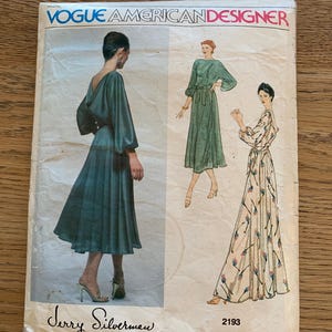 May include: Vintage Vogue American Designer sewing pattern featuring illustrations of dresses. The pattern cover has the text "Vogue American Designer" and "Jerry Silverman". The pattern number is 2193.