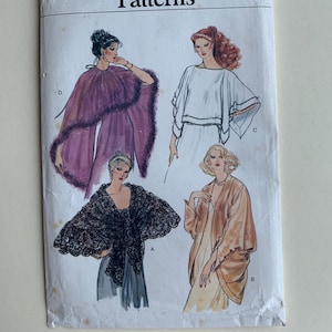 May include: Vogue Patterns sewing pattern number 7233 for four different styles of shawls. The pattern includes instructions for a black lace shawl, a brown shawl, a white shawl, and a purple shawl with a fur trim.