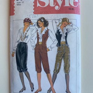 May include: Vintage sewing pattern for a blouse and pants. The pattern is for size 12 and is from the Style pattern book. The pattern shows three women wearing the outfit in different colors and styles.